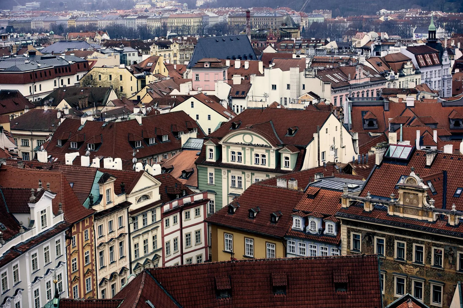 Charming aerial view of Prague's historic rooftops showcasing traditional Czech architecture.