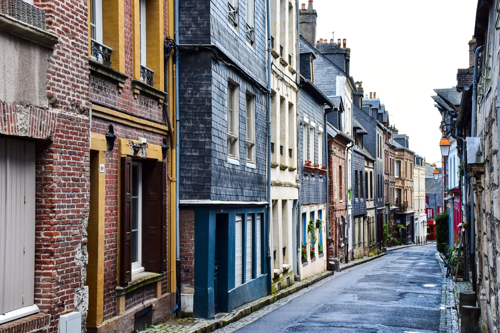 Quaint streetscape of colorful historic buildings in Honfleur, Normandy, France.