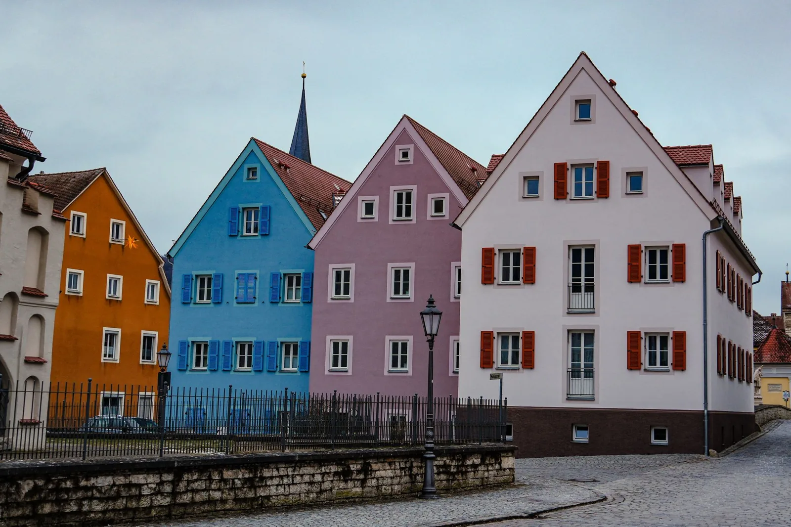A charming view of colorful historic houses on a cobblestone street in Germany, ideal for travel photography.